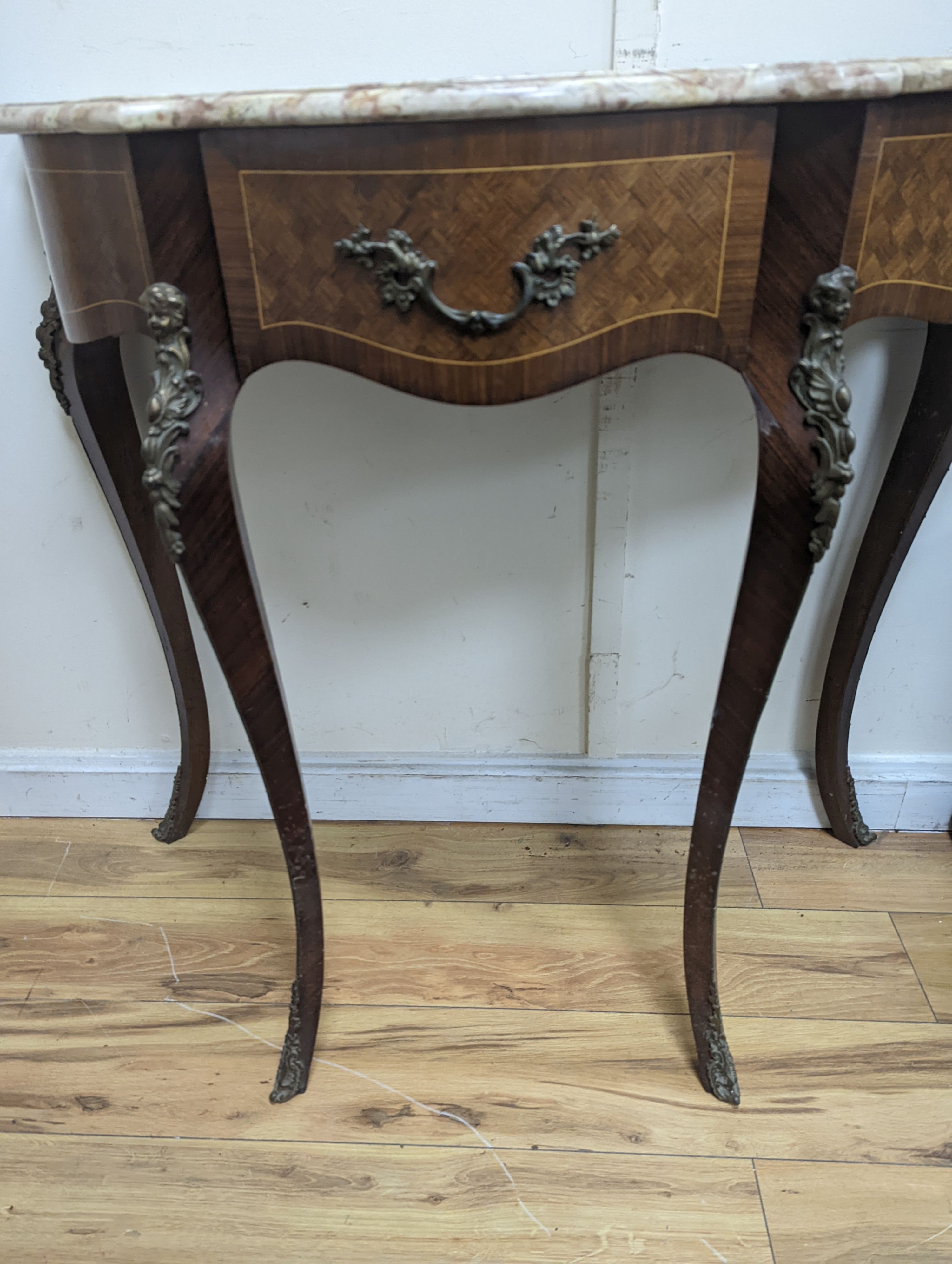 A Louis XVI design marble top serpentine console table. W-102cm, D-47cm, H-91cm.